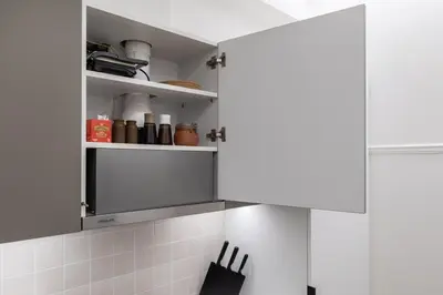 a kitchen with white walls and white cabinets at Viora - Stunning Deluxe Studio in Athens in Athens