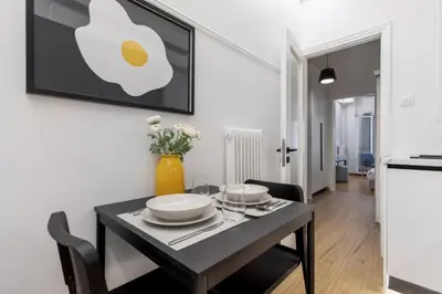 a dining room with a table with plates and flowers at Viora - Stunning Deluxe Studio in Athens in Athens