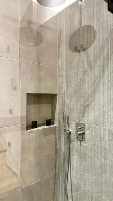 a shower with a glass door in a bathroom at Downtown Modern Studio in Athens