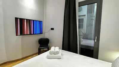 a pair of shoes sitting on a bed in a room at Downtown Modern Studio in Athens