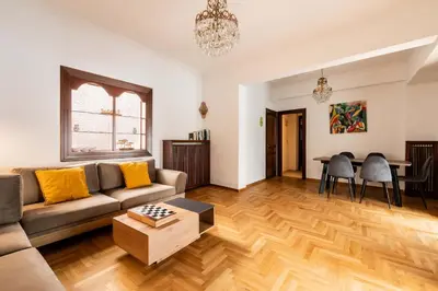 a living room with a couch and a table at Athenian Living in the Heart of Koukaki in Athens