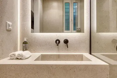 a bathroom sink with a towel and a mirror at Whitewood Residence in Athens