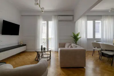 a living room with a couch and a table at Timeless Plaka Retreat in Athens