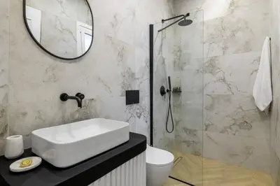 a bathroom with a sink and a shower with a mirror at Timeless Plaka Retreat in Athens