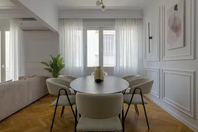 a living room with a table and chairs and a couch at Timeless Plaka Retreat in Athens