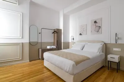 a bedroom with a large bed and a mirror at Timeless Plaka Retreat in Athens