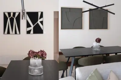 a dining room with tables and chairs and paintings at Comfort Seaside 2BR Apartment in Palaio Faliro by UPSTREET in Athens