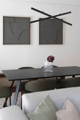 a dining room table with a vase of flowers on it at Comfort Seaside 2BR Apartment in Palaio Faliro by UPSTREET in Athens