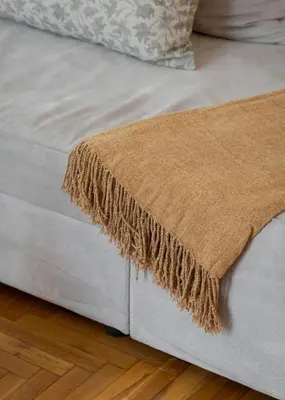 a close up of a blanket on a bed at Acropolis Atmospheric Apartment in Athens