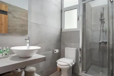 a bathroom with a toilet and a sink and a shower at Acropolis Atmospheric Apartment in Athens