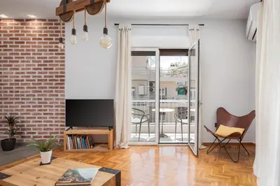 a living room with a brick wall at Acropolis Atmospheric Apartment in Athens
