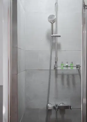 a shower with a glass door in a bathroom at Acropolis Atmospheric Apartment in Athens