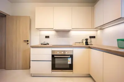 a kitchen with white cabinets and an oven at Marbella Living Pangrati By O&O Group in Athens