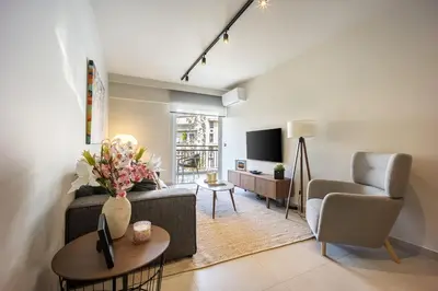 a living room with a couch and a chair at Marbella Living Pangrati By O&O Group in Athens