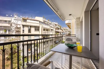 a balcony with a table and a view of a building at Marbella Living Pangrati By O&O Group in Athens
