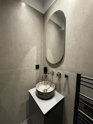 a bathroom with a sink and a mirror at Downtown Modern Suite in Athens