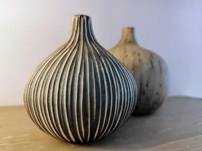 three vases sitting on top of a table at Spacious modern flat in Koukaki in Athens