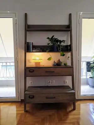 a dresser with plants on it in a room at Spacious modern flat in Koukaki in Athens