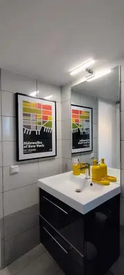 a bathroom with a sink and a mirror at Spacious modern flat in Koukaki in Athens