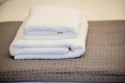three towels stacked on top of each other in a bathroom at Nikki's Skylight Suite in Athens