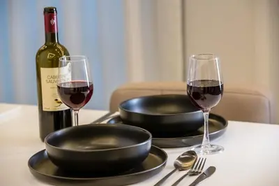 a table with a bottle of wine and two glasses at Nikki's Skylight Suite in Athens
