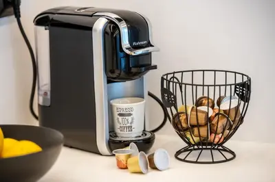a coffee maker and a basket of muffins on a counter at Nikki's Skylight Suite in Athens