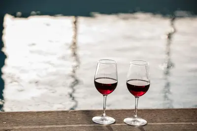 two glasses of red wine sitting on a table at Nikki's Skylight Suite in Athens
