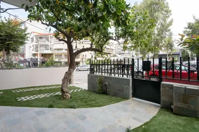 a tree in a yard next to a fence at The One With The Lemon Tree in Athens