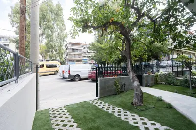 a tree in a yard next to a fence at The One With The Lemon Tree in Athens