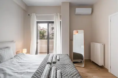 a bedroom with a bed and a large window at The One With The Lemon Tree in Athens