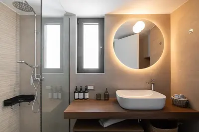 a bathroom with a sink and a shower and a mirror at The One With The Lemon Tree in Athens