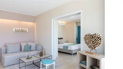 a living room with a couch and a bedroom at 2BD Luxury Sea View Penthouse in Astir Beach in Athens