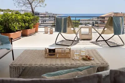 a table with a tray of food and glasses on a balcony at 2BD Luxury Sea View Penthouse in Astir Beach in Athens