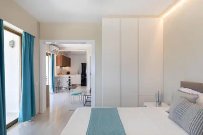 a bedroom with a bed and a living room at 2BD Luxury Sea View Penthouse in Astir Beach in Athens