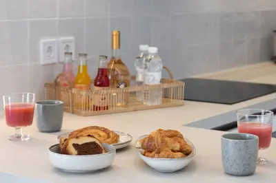 a kitchen counter with two bowls of pastries and drinks at 2BD Luxury Sea View Penthouse in Astir Beach in Athens