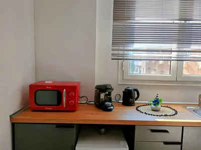 a red microwave sitting on top of a kitchen counter at Aiolou 68str rooms & apartments in Athens