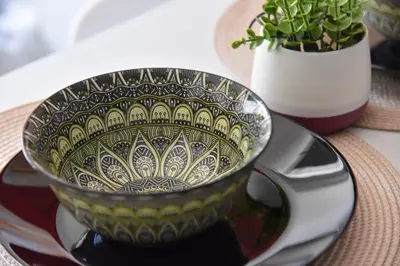 a black and white bowl on a plate on a table at Aiolou 68str rooms & apartments in Athens