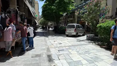 a group of people walking down a street at Aiolou 68str rooms & apartments in Athens