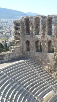 an empty amphitheater with a city in the background at Aiolou street rooms & apartments# in Athens