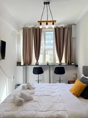 a bedroom with a large white bed with towels on it at Aiolou street rooms & apartments# in Athens