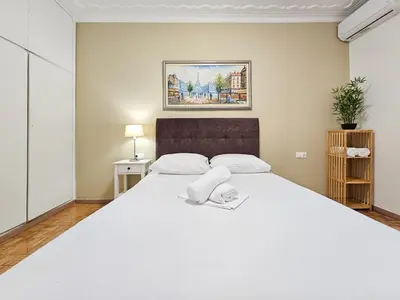 a bedroom with a large white bed in a room at Casa Divas City Stay in Athens