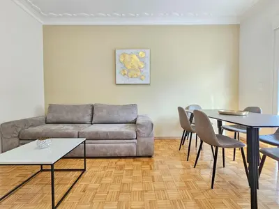 a living room with a couch and a table and chairs at Casa Divas City Stay in Athens