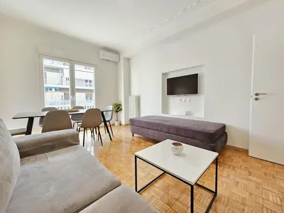 a living room with a couch and a table at Casa Divas City Stay in Athens