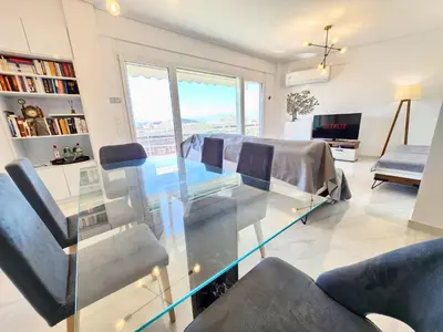 a living room with a glass table and chairs at Acropolis Vista View in Athens