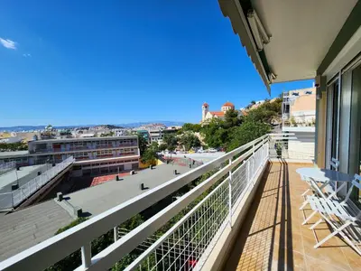 a balcony with chairs and a view of a city at Acropolis Vista View in Athens