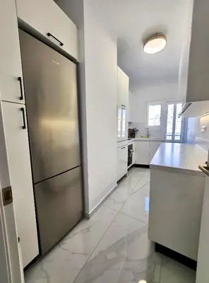 a large kitchen with a stainless steel refrigerator at Acropolis Vista View in Athens