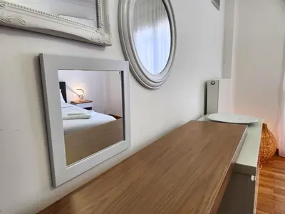 a bedroom with a mirror and a bed at Acropolis Vista View in Athens