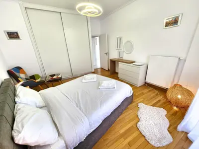 a bedroom with a large white bed in a room at Acropolis Vista View in Athens