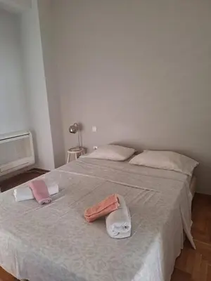 a bedroom with two towels on a bed at Cozy renovated flat with balcony in Athens
