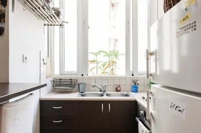 a kitchen with a sink and a window at Cozy renovated flat with balcony in Athens